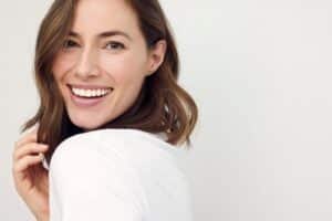 closeup portrait of young happy woman looking in camera