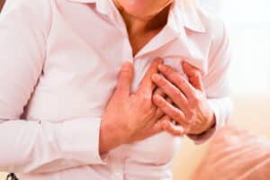 A close-up shot of a woman clutching her chest